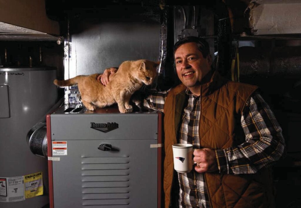 Ipswich Program Recipient Mark, with his cat and a cup of coffee