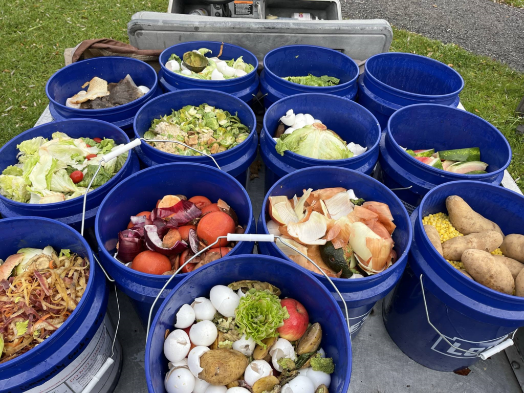 Buckets of produce scraps, eggshells, and other backyard compostable items are picked up each week and taken to the compost.