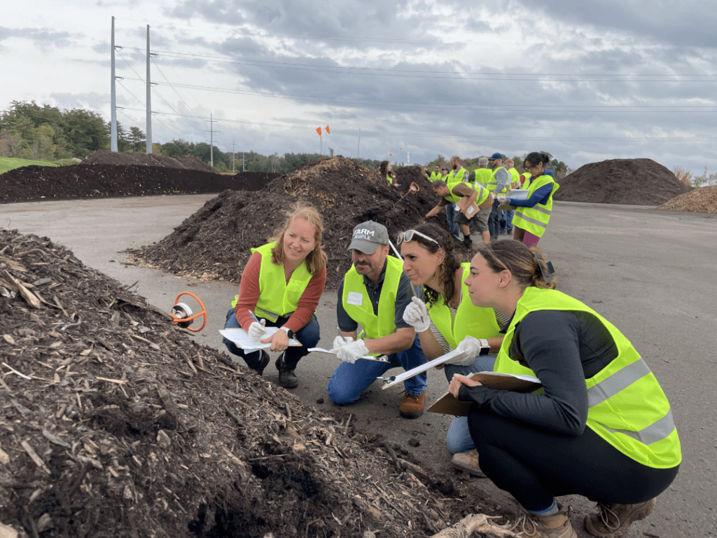 Attendees learning about compost piles