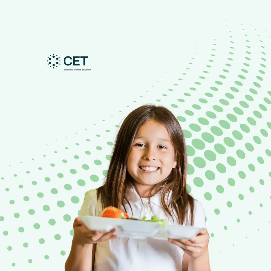 A studen holding a dish from a school cafeteria