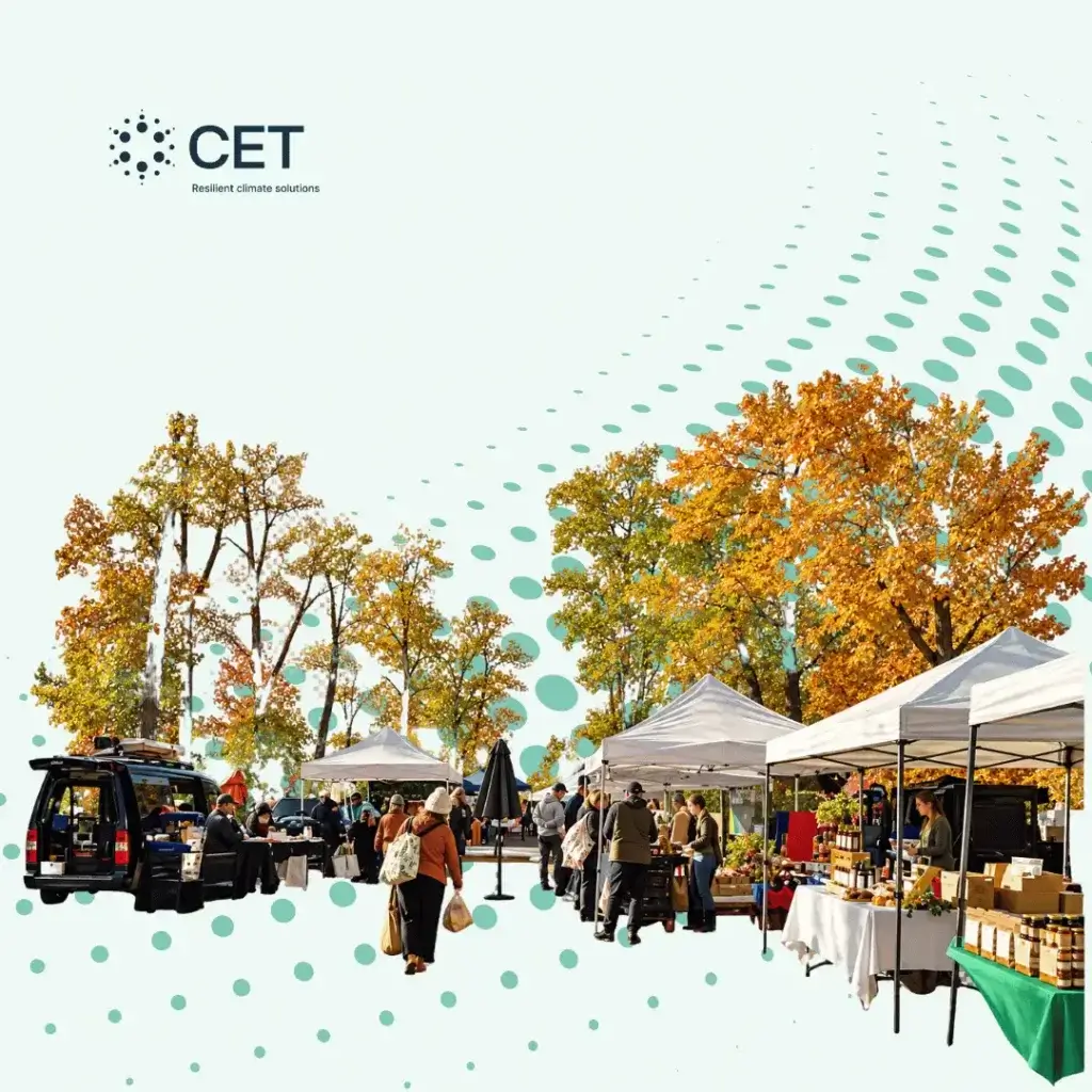 Outdoor farmers market in Cold Spring, New York, with shoppers, food vendors, white canopy tents, and autumn trees.