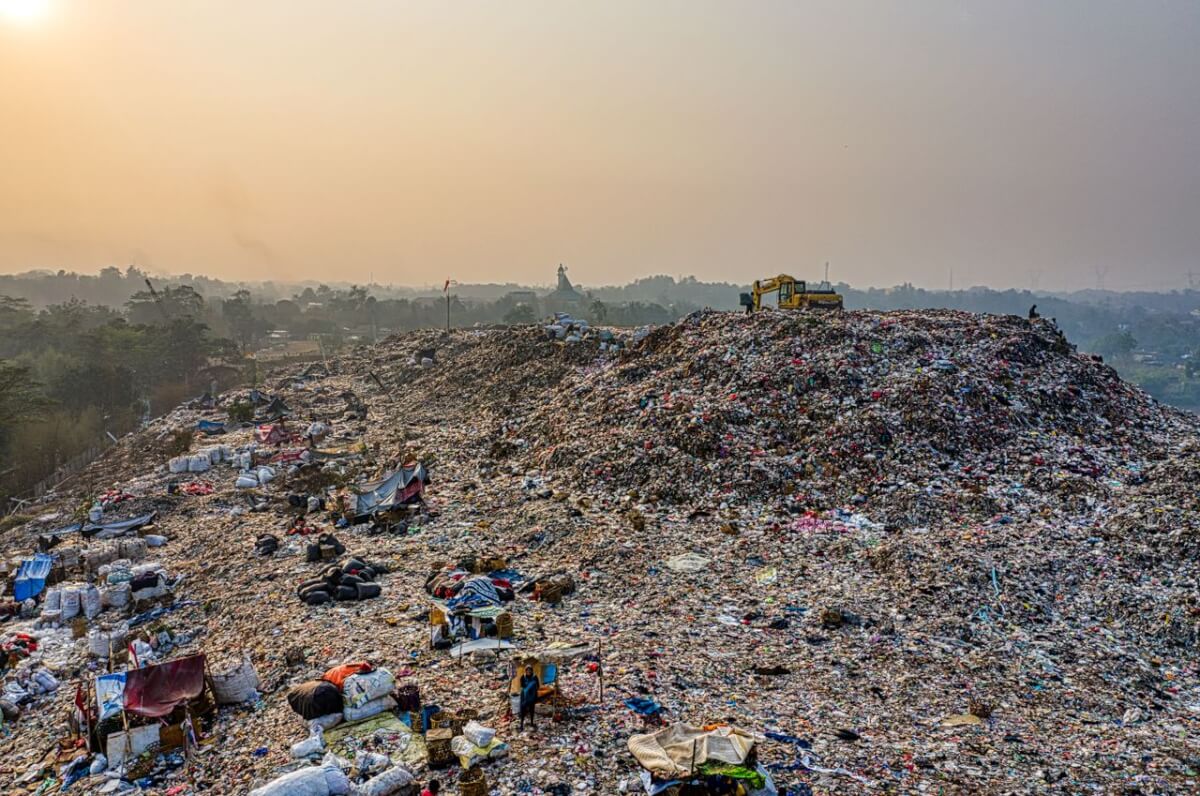 Aerial shot of a large landfill with garbage piles, showcasing waste management challenges.